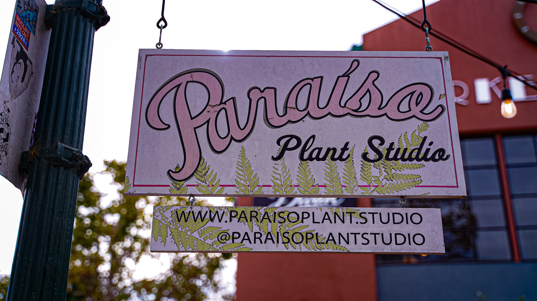 Paraiso Plant Studio hanging sign beside the event location