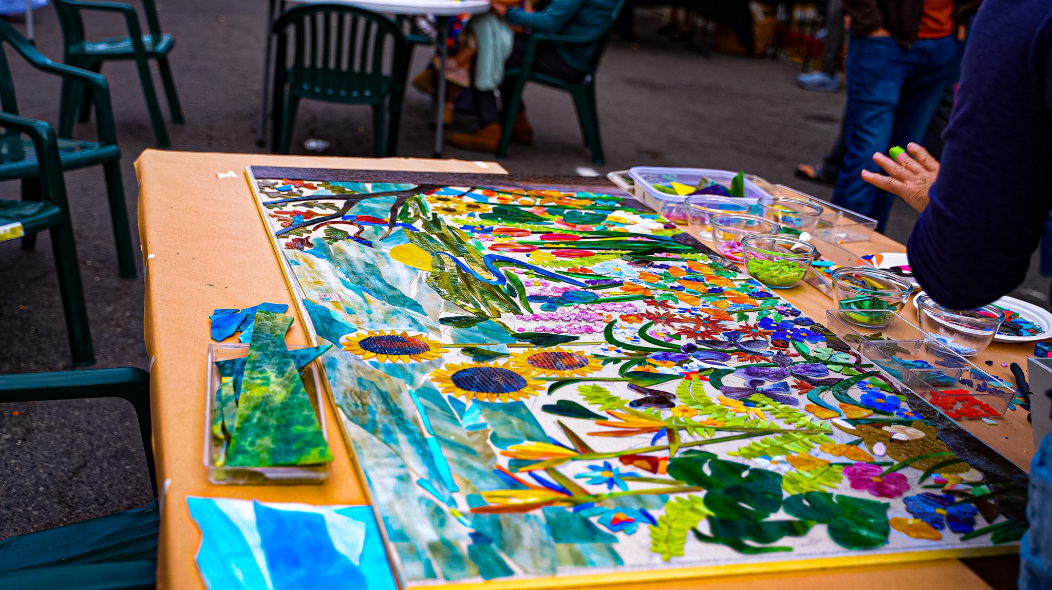 Colorful collaborative mosaic and art materials on an event table